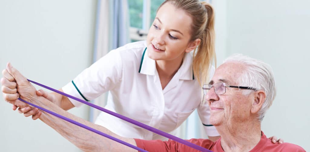 Senior Male Working With Physiotherapist