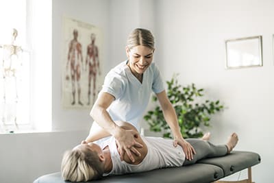 A Modern rehabilitation physiotherapy worker with woman client