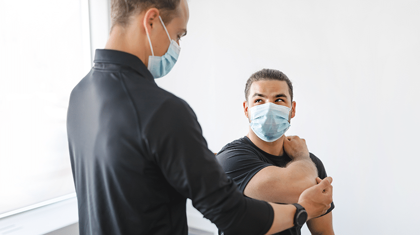 PT treating patient with face masks
