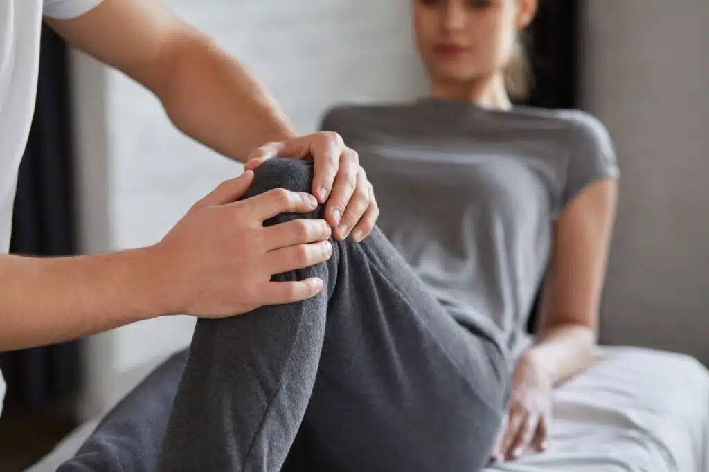 Female patient doing physical exercises with a physiotherapist.