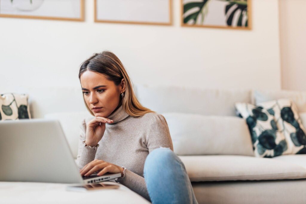 A young woman searching for chiropractic information online.