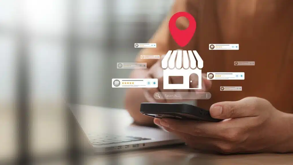 A person using a smartphone with a digital overlay showing a storefront icon, a red location pin, and various five-star customer rating bubbles.