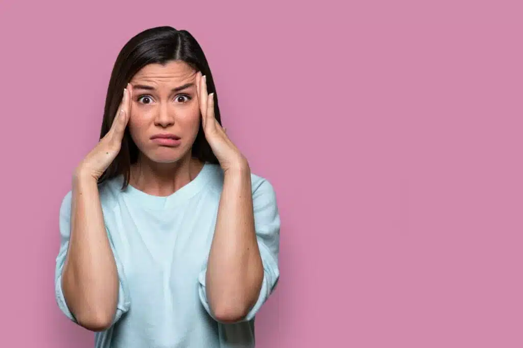 Isolated facial expression of a worried, concerned, fearful, regretful woman.